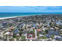 Breathtaking aerial view showcases the coastal neighborhood, nearby beach, and this home's waterfront canal location at 5572 Shadow Lawn Dr, Sarasota, FL 34242