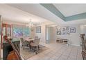Open-concept dining room with chandelier, tiled floors, neutral paint and a large window at 6472 Seagull Dr # 301, Bradenton, FL 34210
