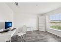 Bright office space with a large window and modern desk, chair, and bookcase at 6528 166Th E Pl, Parrish, FL 34219