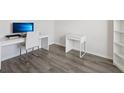 Bright office space with a modern desk, chair, and bookcase, plus luxury vinyl flooring at 6528 166Th E Pl, Parrish, FL 34219