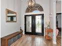 A bright foyer features stylish tile flooring, a decorative light fixture, and a transom window at 6845 74Th Street E Cir, Bradenton, FL 34203