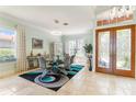 Formal dining area boasting unique light fixture and decorative front door at 7521 Aralia Way, Seminole, FL 33777