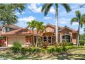 Charming curb appeal with lush landscaping, brick pavers and a clay tile roof at 7521 Aralia Way, Seminole, FL 33777