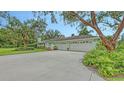 Large three-car garage with beautiful landscaping at 7604 Weeping Willow Cir, Sarasota, FL 34241