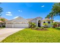 Stunning single-story home with lush landscaping, beautiful lawn, and a three-car garage at 7727 Heyward Cir, University Park, FL 34201