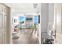 Bright living room featuring water views from large windows, sleek furniture, and modern decor at 800 N Tamiami Trl # 405, Sarasota, FL 34236