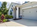 A well-maintained home featuring a two-car garage, neutral paint, and neatly landscaped front yard at 8706 Arrow Creek Dr, Parrish, FL 34219