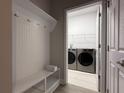 Convenient laundry room with modern washer, dryer, and ample storage space at 8706 Arrow Creek Dr, Parrish, FL 34219