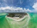 Panoramic aerial shot of a coastal community surrounded by crystal-clear turquoise waters and sandy beaches at 8750 Midnight Pass Rd # 501, Sarasota, FL 34242