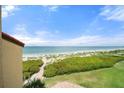 Enjoy unobstructed ocean views from this beachside condo with lush greenery below and a pathway to the sand at 8750 Midnight Pass Rd # 501, Sarasota, FL 34242
