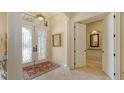 Grand foyer with decorative tile flooring and elegant double doors at 8832 Enclave Ct, Sarasota, FL 34238
