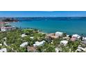 Aerial view of a coastal community, showcasing a property with stunning water views at 1076 Toc0Baga, Sarasota, FL 34234