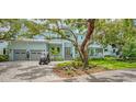A bright, light blue two-story home with a paver driveway and an oversized 2-car garage at 1076 Toc0Baga, Sarasota, FL 34234