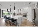 Modern eat-in kitchen with a waterfall island, stainless steel appliances, and sleek cabinetry at 11422 Apple Tree Cir, Bradenton, FL 34211