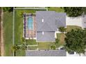 Aerial view of the backyard featuring a screened-in pool, lush green grass, and a privacy fence at 11839 Shrewsbury Ln, Parrish, FL 34219