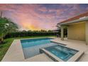Inviting pool and spa with a manicured yard perfect for outdoor living and relaxation at sunset at 12814 Daisy Pl, Bradenton, FL 34212