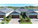 Beautiful home with a two-car garage, surrounded by picturesque water views and lush landscaping at 12827 Lily Quartz Loop, Parrish, FL 34219
