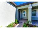 Inviting front entrance with a charming brick pathway and a well-maintained exterior at 12827 Lily Quartz Loop, Parrish, FL 34219