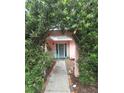 Inviting front entrance with a decorative archway, lush greenery, and a cozy sitting area at 1308 63Rd Nw St, Bradenton, FL 34209