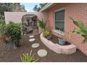Front garden area with stepping stones leading to a private patio with rock garden, mature shrubs and walkway at 1308 63Rd Nw St, Bradenton, FL 34209