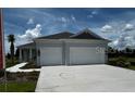 Well-maintained single-story home featuring a two-car garage and a lush green lawn at 13908 Painted Loop, Parrish, FL 34219