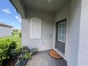 Welcoming entryway with a decorative sidelight, a modern door with a window, and a cozy doormat at 16087 Sunny Day Dr, Bradenton, FL 34211