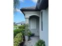 A charming exterior corner showcases a home's architectural details, well-maintained landscaping, and an inviting entryway at 16087 Sunny Day Dr, Bradenton, FL 34211