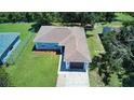 An aerial view of a well-manicured home featuring a one-car garage and a spacious backyard at 1707 24Th E St, Palmetto, FL 34221