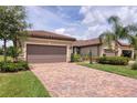 Beautiful home featuring a paved driveway, two-car garage, and well-maintained landscaping at 17648 Northwood Pl, Lakewood Ranch, FL 34202