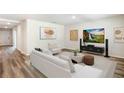 Spacious living room with modern furnishings and decor, including a large screen television at 1766 Cobb Trl, Parrish, FL 34219