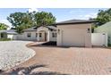 Charming single story home featuring a brick driveway, manicured landscaping, and attached garage at 1881 Orchid St, Sarasota, FL 34239