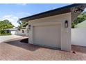 Close up on the attached, single car garage and brick driveway at 1881 Orchid St, Sarasota, FL 34239
