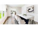 Bright dining room with modern table, chairs, stylish rug, and view to living area at 1914 Cobb Trl, Parrish, FL 34219