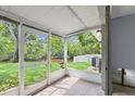 Enclosed porch offering outdoor views of the backyard and the tranquil waterway beyond at 2115 9Th W Ave # 3D, Bradenton, FL 34205
