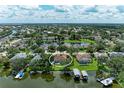 Lakefront home with a private dock and screened in pool, surrounded by trees and scenic views at 220 39Th Ne St, Bradenton, FL 34208