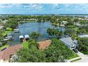 Aerial view showcasing lakefront property with lush landscaping, private docks, and serene water views at 220 39Th Ne St, Bradenton, FL 34208