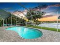 Relaxing screened pool overlooking a tranquil lake, complete with comfortable seating and picturesque views at 220 39Th Ne St, Bradenton, FL 34208