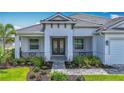 Inviting home with lush landscaping, a tile roof, and a decorative glass double-door front entrance at 3512 Cross Creek Pkwy, Parrish, FL 34219