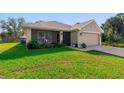 Beautiful single-story home featuring a well-manicured lawn, a two-car garage, and a screened front porch at 3524 Brownwood Ter, North Port, FL 34286