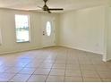 Bright, spacious living room with tile flooring, a ceiling fan and a large window with abundant natural light at 4112 Cochise Ter, Sarasota, FL 34233