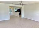 Open-concept living room with tile flooring, connecting seamlessly to dining and kitchen areas at 4112 Cochise Ter, Sarasota, FL 34233