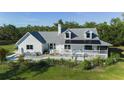 Bright home with a charming porch, adorned with solar panels for energy efficiency at 4888 Old Ranch Rd, Sarasota, FL 34241