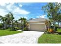 Inviting single-story home featuring a paver driveway, tan exterior, and tile roof at 5080 Timber Chase Way, Sarasota, FL 34238