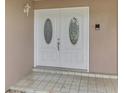 Elegant double front doors with decorative glass inserts for a welcoming entry at 5124 Palm Aire Dr, Sarasota, FL 34243