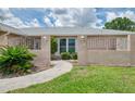 Inviting front entrance with decorative white railings and a beautifully landscaped walkway at 5124 Palm Aire Dr, Sarasota, FL 34243