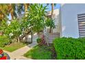 Condominium building featuring mature trees and lush landscaping at 548 Lakeside Dr # 0, Bradenton, FL 34210