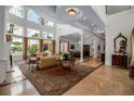 Bright and airy living room with high ceilings, large windows, and seamless flow to dining room at 550 Dove Pointe, Osprey, FL 34229