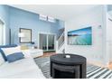 Bright, open living room with modern furniture, high ceilings, and a large flat screen television at 6005 N Beach Rd # 16, Englewood, FL 34223