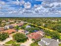Stunning aerial view of neighborhood homes surrounding a peaceful pond in a well-maintained community at 6610 Rosy Barb Ct, Lakewood Ranch, FL 34202