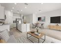 Open-concept floor plan featuring a living room, dining area, and kitchen with stainless steel appliances at 8705 Winter Breeze Way, Sarasota, FL 34241